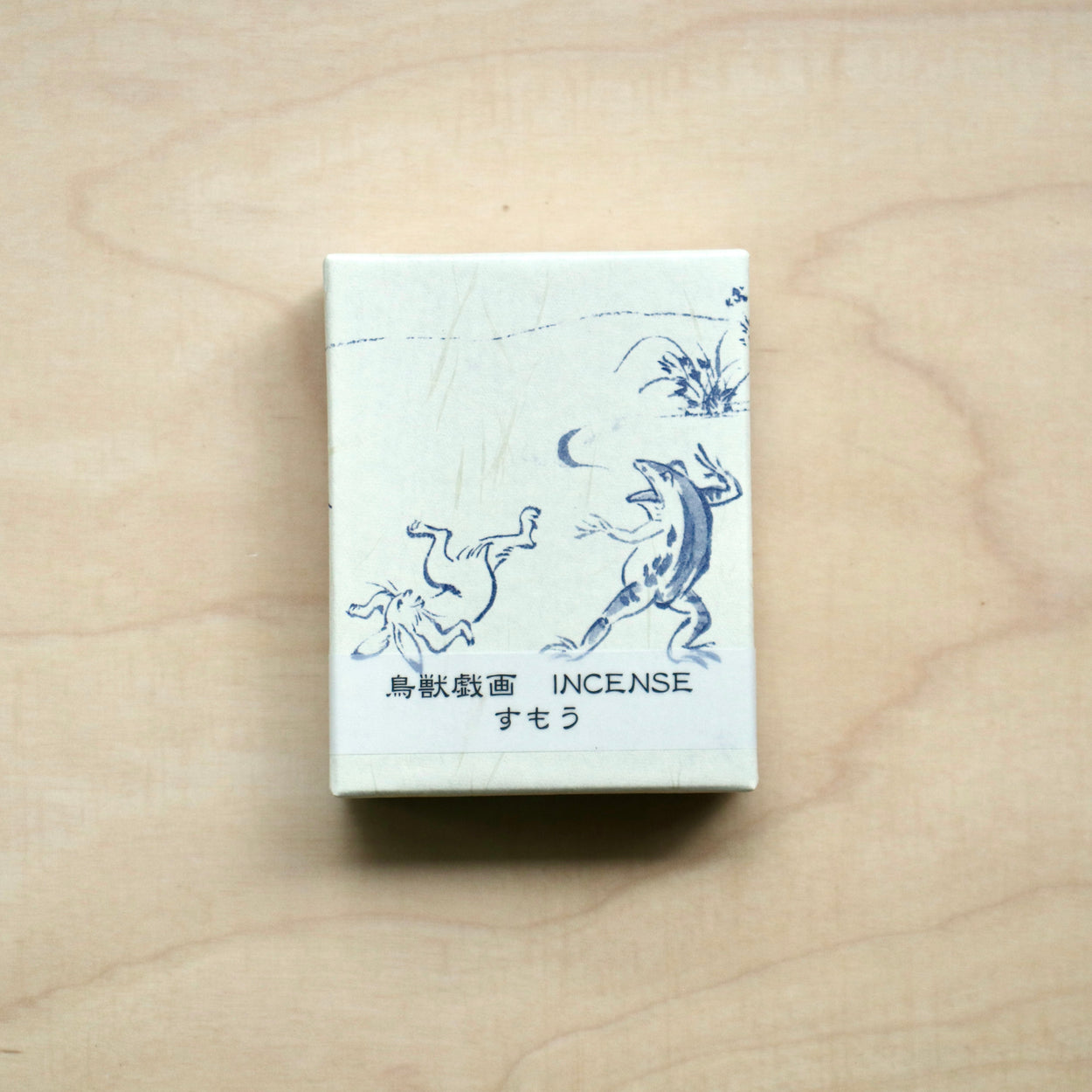 Japanese Incense Sticks box- Sumo on pale wood backdrop.