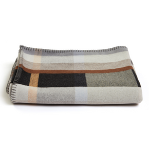 Wallace Sewell Premium Chipperfield  Merino lambswool throw in pale brown tones, folded.