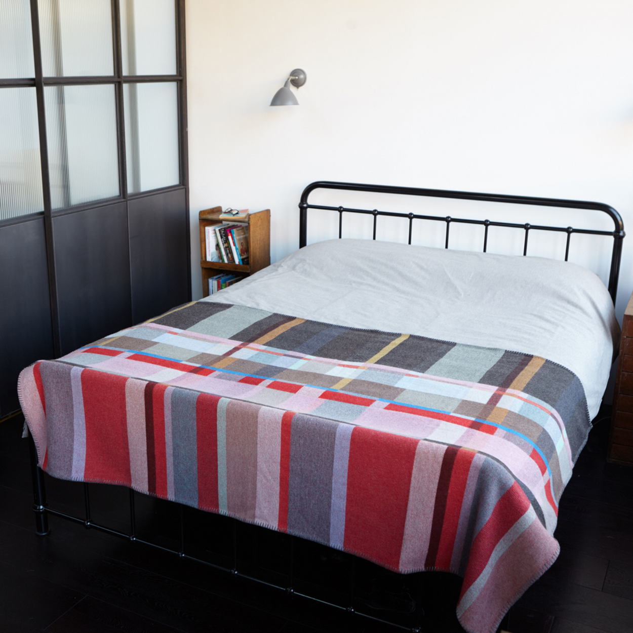 Wallace Sewell Premium Lasdun Merino Lambswool blanket draped on end of bed,