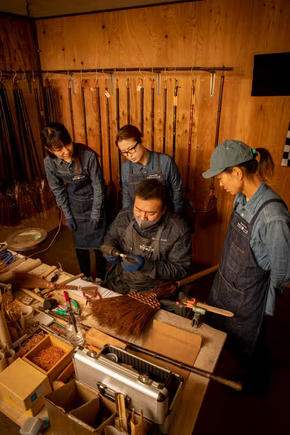 Japanese Harimi Dustpan workshop artisan demonstrating to young workshop women.