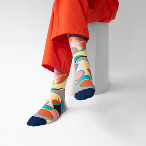 Person in red pants wearing Bonne Maison Patchwork socks against a white backdrop.
