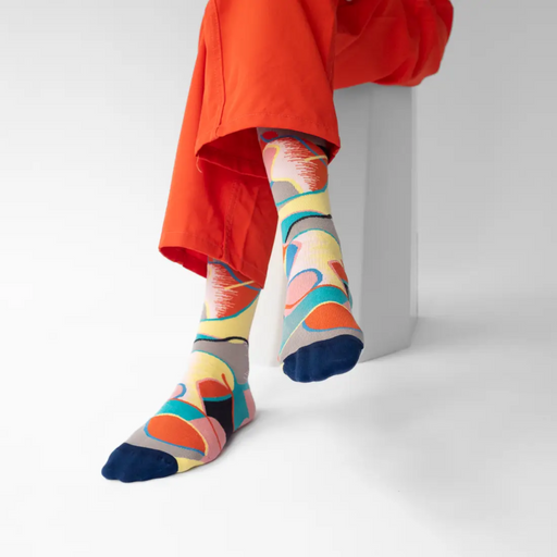Person in red pants wearing Bonne Maison Patchwork socks against a white backdrop.