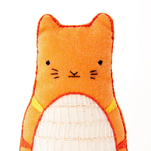 Orange cat-shaped plush toy with a white belly on a white background
