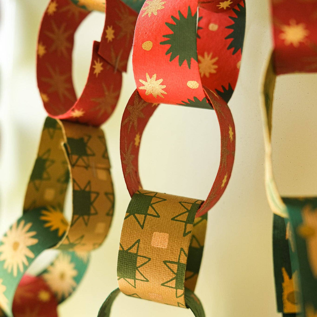Colorful paper chain with festive patterns on a blurred background