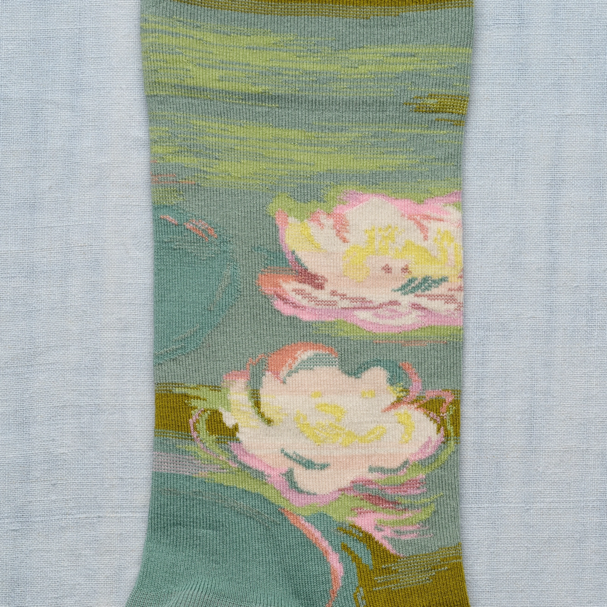 Close up of Waterlily Bonne Maison socks on white backdrop.