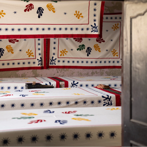Decorative tablecloth workshop with colourful patterns on a table