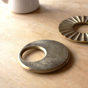 Futagami Brass Moon Trivets on table top.