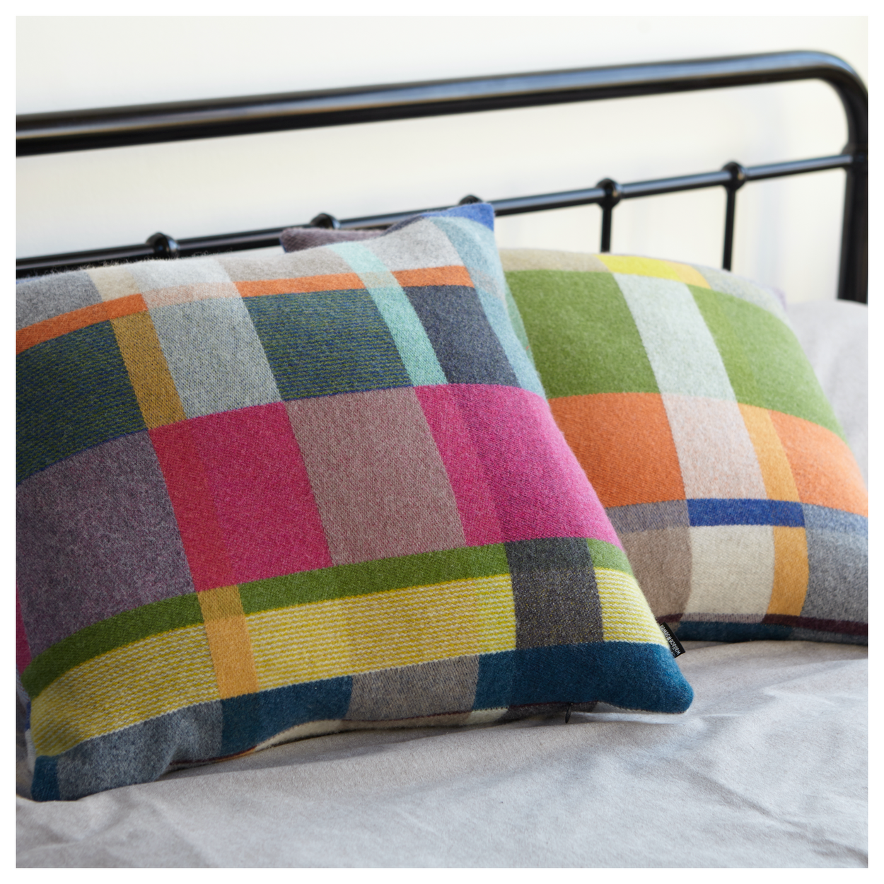 Two Premium Australian Merino Wool Cushion cover - Gwynne stuffed, on iron bed.