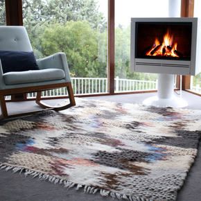 Hand woven pure wool rug - blue in sitting room with rocking chair and white fireplace