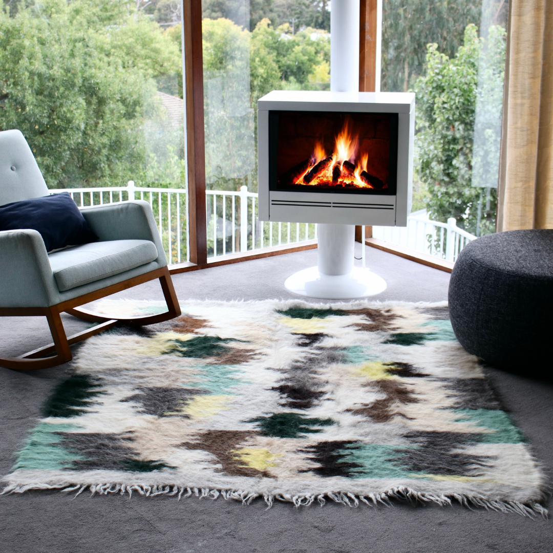 Handmade Large pure wool rug - green in sitting room with rocking chair and white fireplace