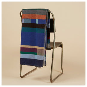 Antoni Blue Premium Merino Lambswool wool throw blanket on back of chair