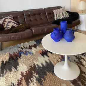 Hand Woven Pure Wool Rug - Blue close up with leather sofa, round table and blue vases.