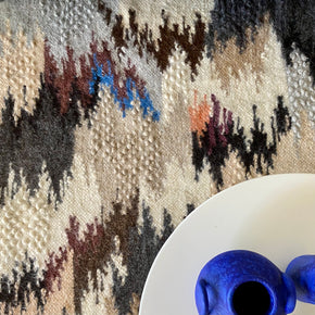 Hand Woven Pure Wool Rug - Blue close up with round table and blue vases.