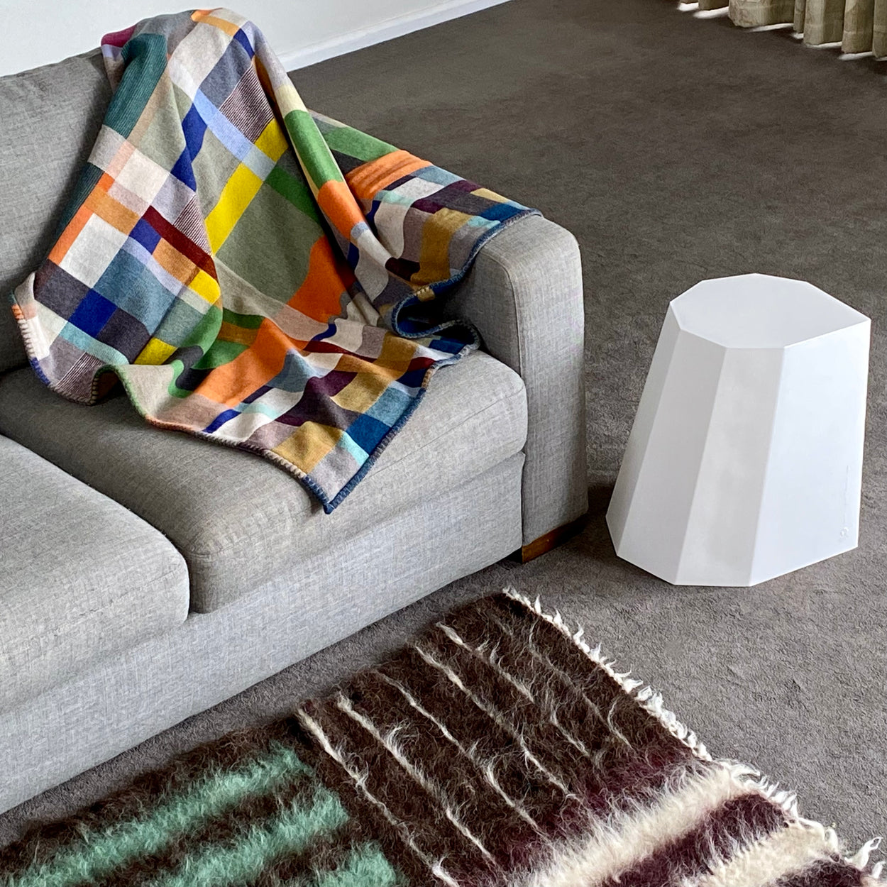 Premium Australian Merino Wool Throw Blanket - Gwynne on grey sofa next to white cotton Arnold Circus Stool