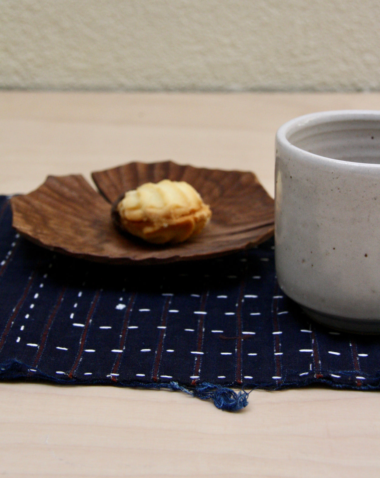 Vintage Japanese Indigo Placemat with wood lotus plate and handmade ceramic cup by Richard Beauchamp