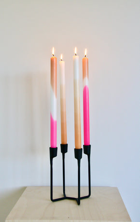Hand Dipped Dinner Candles - Pink and Orange with Orange Ombre candles in a black candle holder with white background.
