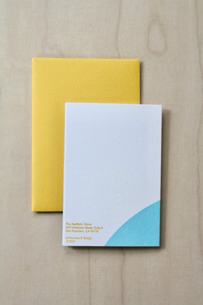 Back of Hand printed greeting card with yellow sun and blue curve on a yellow envelope. reading "Three things cannot be long hidden, the sun, the moon and the truth" Buddha