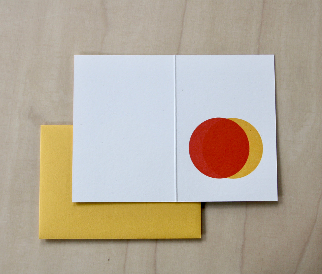 Inside of Hand printed greeting card with yellow and red overlapping suns with a yellow envelope. reading "Three things cannot be long hidden, the sun, the moon and the truth" Buddha