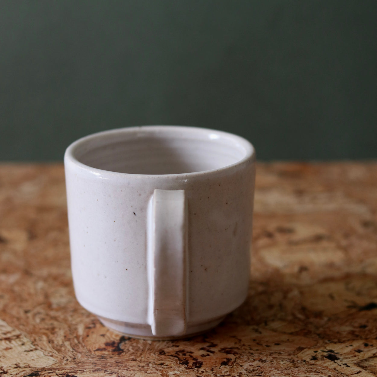 Handmade Ceramic Coffee Mug - Large by Richard Beauchamp, handle view, on cork background.