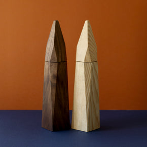 Walnut and Ash wood salt and pepper grinders by Martino Gamper with blue and brown background