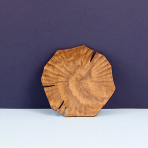 Hand carved Lotus leaf walnut wood plate standing upright.