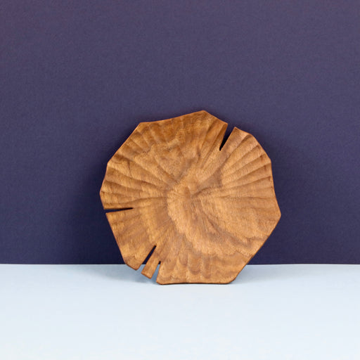 Hand carved Lotus leaf walnut wood plate standing upright.