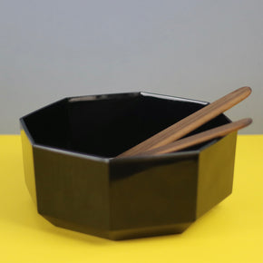 Handmade Walnut Wood Salad Servers in a black 80s bowl with a grey and yellow background. By Civil Dawn Studio.