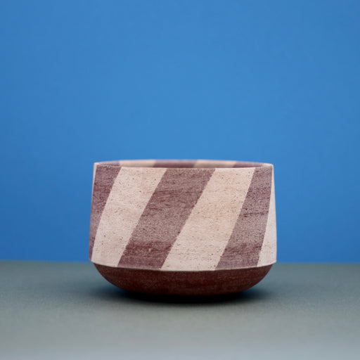 Ceramic Medium Stripe Bowl by Amanda-Sue Rope with blue green background.
