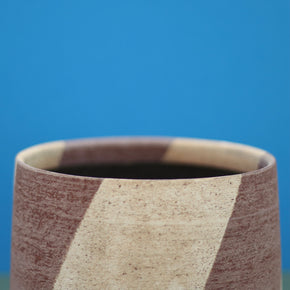Ceramic Stripe Bowl by Amanda-Sue Rope with blue green background.  Rim close up.