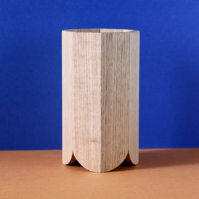 Handmade Wood Kitchen Utensil Holder in oak against a blue and brown background.