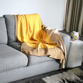 Desert Sun cotton knit throw blanket on grey sofa