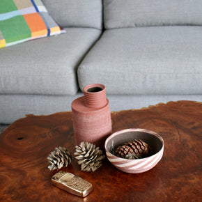 Ceramic Thin Stripe Bowl by Amanda-Sue Rope on burl wood coffee table with vase and Nancy Pearce phone sculpture