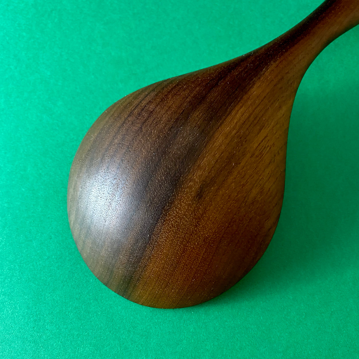 Close up view of Handmade Walnut Wood Soup Ladle with green  background by Civil Dawn Studio