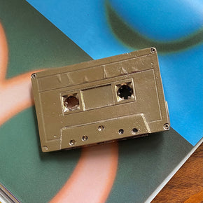 Bronze Cassette Mix Tape by Nancy Pearce on blue green book interior