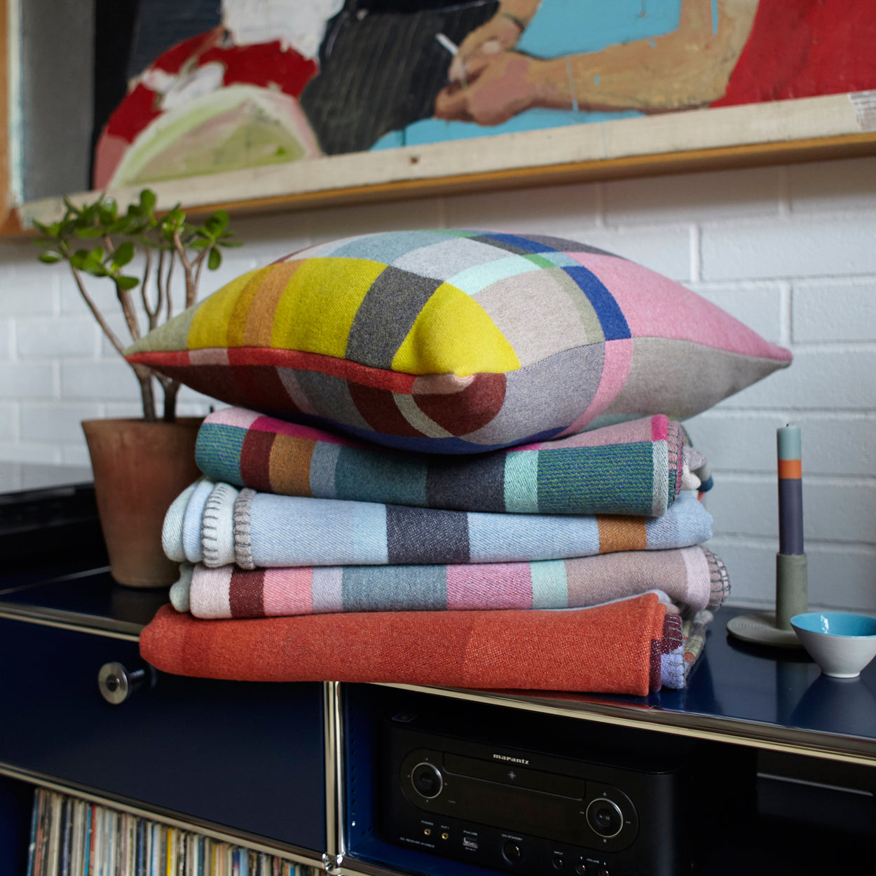 Premium Merino wool cushion cover in Lloyd with blankets on buffet top.