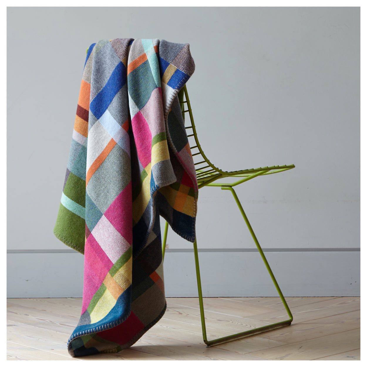 Premium Australian Merino Wool Throw Blanket in bright pink and blue on chair