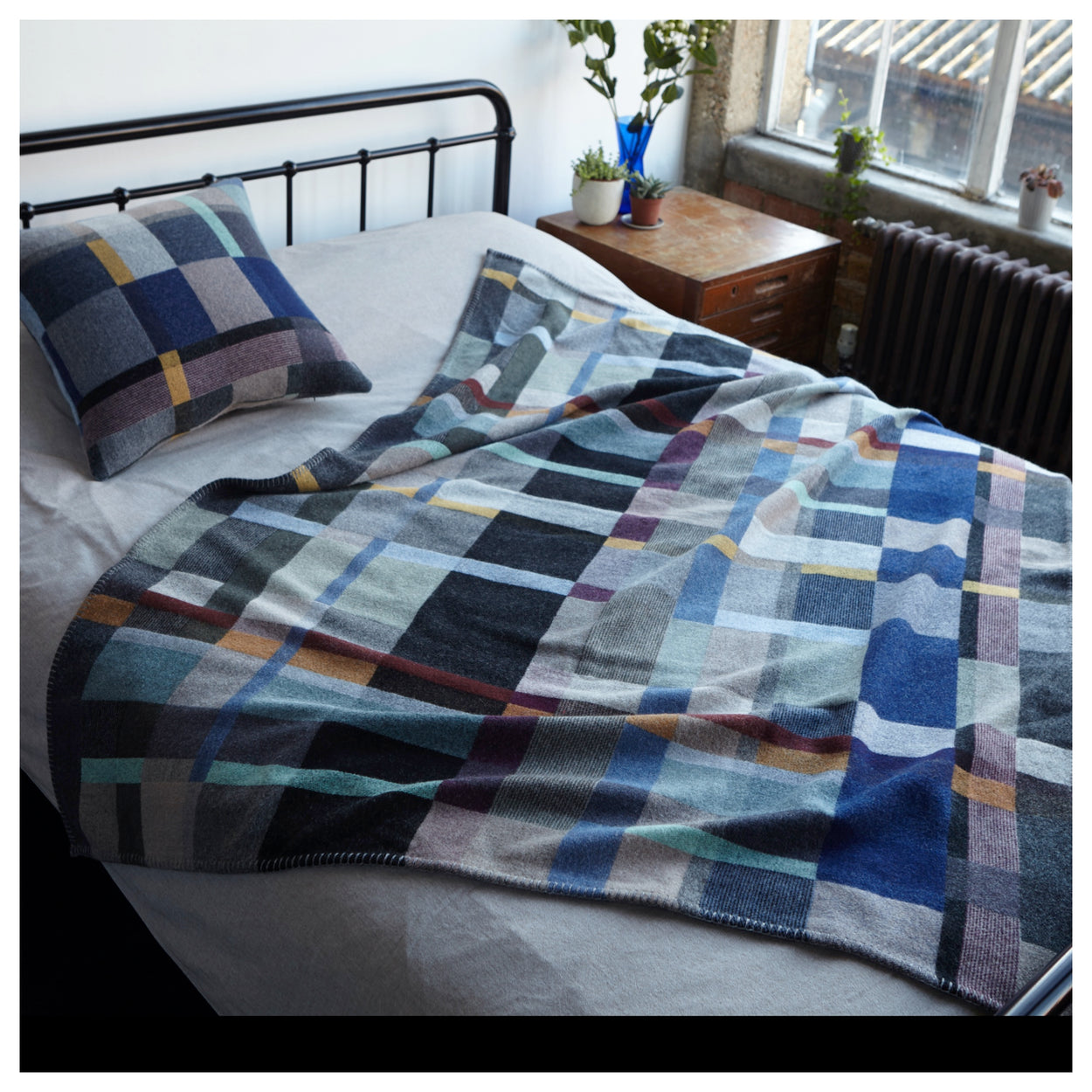 Premium Merino Lambswool throw blanket - Erno Blue, Grey & Grape block on bed