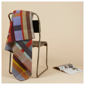 Cecil Orange and brown Premium Merino Lambswool wool throw blanket on chair with magazine
